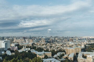 top panoramic view of baku city with huge area with buildings and parks around Icheri Sheher over cloudy sky