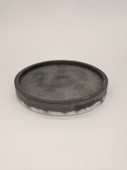 A unique round concrete tray with a smooth gray finish and subtle texture, perfect for contemporary home decor.
