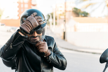 Biker putting on helmet and gloves getting ready for ride