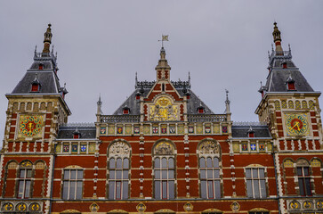 Beautiful aerial view of  Amsterdam Centraal Train Station and its historic hub with canals, bikes, cafes. Netherlands