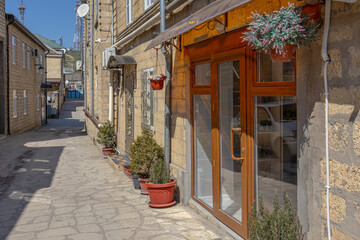 Ancient quarters of the city of Derbent. The private sector in the ancient city. The streets in the old quarters are paved with paving stones. Ancient sandstone houses. Narrow ancient streets.