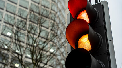 Red and amber traffic lights in an urban setting