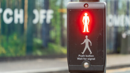 Pedestrian crossing signal with red stop light in city