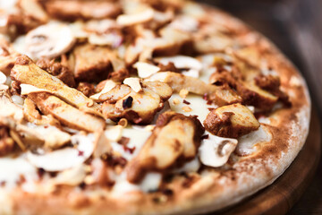 Gyros Pizza with with champignons and mozzarella cheese. Wooden background. Soft focus.