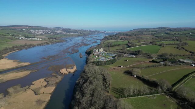 River Teign, South Devon, England: DRONE VIEWS: The drone reverses over the River Teign and A381 road bridge as traffic flows; the Teign estuary and Teignmouth are in the distance. South Devon is a po