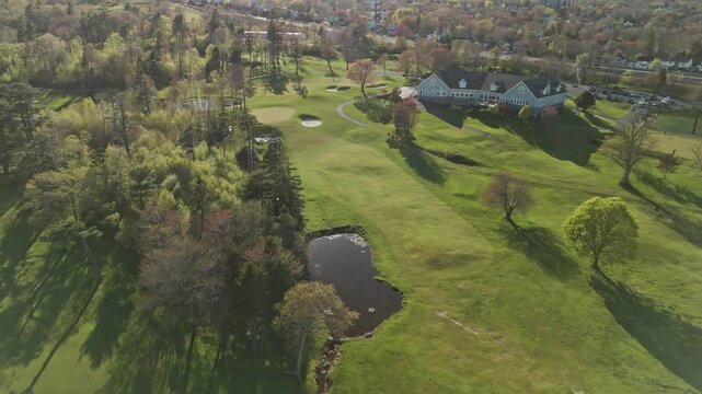 Aerial View Golf Course, Where Players Are Competing And Groundskeepers Are Maintaining The Field. The Footage Showcases The Beauty Course, Highlighting The Work Behind A Pristine Golfing Experience.