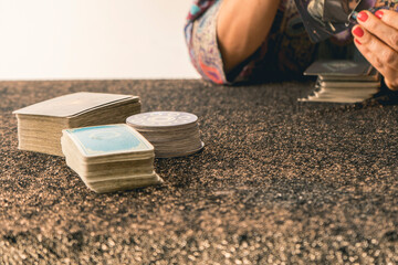 Fortune teller shuffling tarot cards on a table
