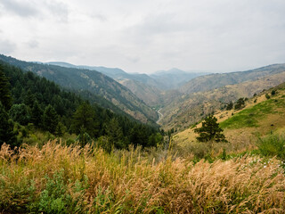 Naklejka premium Cascades of mountains come together around a winding road below.