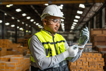 Close up technician engineer wearing and adjust protective safety glove. Safety equipment for...