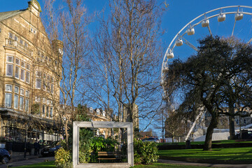 A picturesque Harrogate town centre scene with a Ferris wheel and historic buildings,Yorkshire, UK.