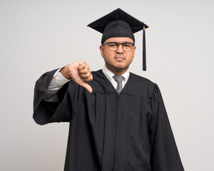 Various action. Stressed angry Young Asian man in graduation costume with cap on isolated...