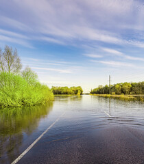 Road is flooded with water and the sky is blue
