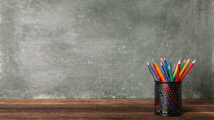Close-up of a bank with pencils and pens on the background of the school board, copy space, back to...