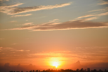 Orange sky with clouds at sunset