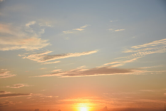 Orange sky with clouds at sunset