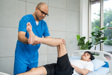 Obraz premium Physical therapy. Male Nurse aids young man in recovering from spine injury and providing orthopedic massage Orthopedic healthcare and chiropractor with person for physical therapy rehabilitation