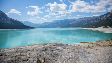 Wide blue lake in a wild rustic mountain valley 