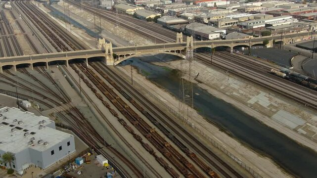 Arial shot of Los Angeles historic road bridge over river and railroad tracks. LA's Union Station and the freight yard. California