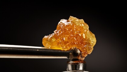 live rosin on a dab tool with a black background