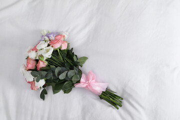 Wedding bouquet of beautiful flowers on linens, top view. Space for text