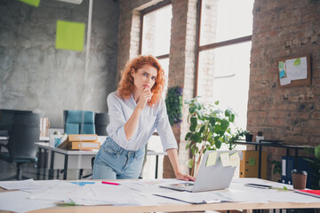 Portrait of young corporate worker lady contemplate use laptop modern loft interior business center...