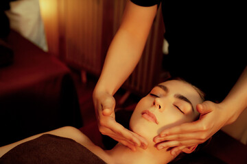 Caucasian woman enjoying relaxing anti-stress head massage and pampering facial beauty skin...