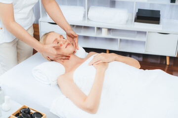Caucasian woman enjoying relaxing anti-stress head massage and pampering facial beauty skin...
