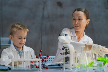A young scientist and a child conducting an experiment in a laboratory. Encouraging curiosity, STEM...