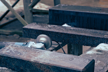 angle grinder with diamond grinding wheel and pieces of granite in stone workshop