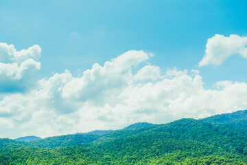 Obraz premium Blue sky with the mountains view on a sunny summer day mountain silhouettes,Landscape, Beautiful nature view,white cloud in good day and forest background.