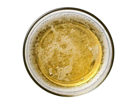 Overhead closeup of a glass filled with a bubbly, golden beverage.  The carbonation is prominent, creating a visually appealing texture.