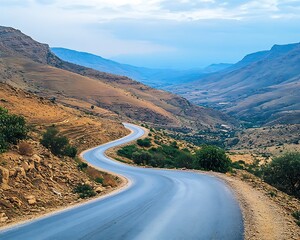 Road curves through valley hills landscape