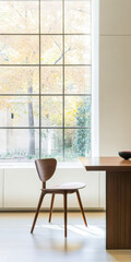 Fototapeta premium Modern chair and table by large window with autumn views in a minimalist room
