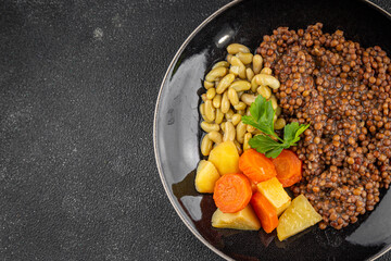 Vegetarian main course vegetables lentils, beans, potatoes, carrots tasty fresh delicious gourmet food background on the table rustic food top view copy space keto and paleo diet vegetarian and vegan 