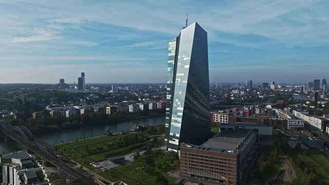 Aerial Drone View of the European Central Bank (Europ&auml;ische Zentralbank), Located Along the Main River in Frankfurt, Germany &ndash; Striking Glass and Steel Skyscraper with a Unique Twisted Design, Standin