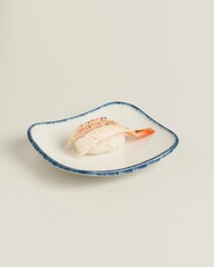 Fresh Sushi Dish with Delicate Fish and Shrimp on a White Plate
