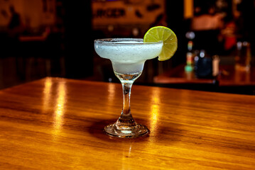 Refreshing Frozen Margarita with Lime and Salt Garnish at Bar Counter