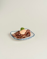 Delicious savory dish of grilled meat with creamy sauce on plate