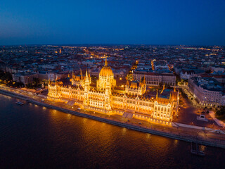 Fototapeta premium Beautiful panorama night city lights against backdrop sunset evening on sunny day in summer view from other bank of Danube River aerial view 