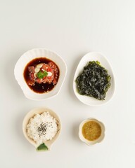 Fresh Seafood Dish with Rice and Seaweed Salad on a White Table