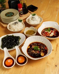 Delicious Asian Cuisine Plate with Rice, Sauces, and Tasty Ingredients