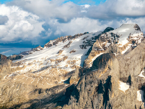 Aerial view beautiful Dolomite mountain Alps dawn range against blue sky on sunny day Italy. Top view drone of high rocks, mountain peaks. Tourism travel concept. Amazing nature scenery in Dolomites