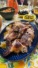 Roasted duck with apples on a blue plate