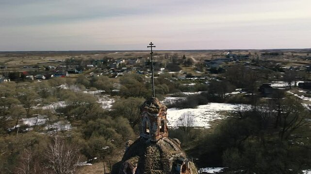 A flight around an old brick church standing in the village in early spring