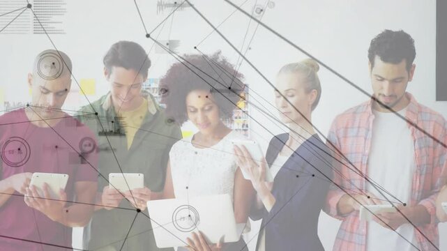 Using tablets, diverse group exploring digital network animation in school setting