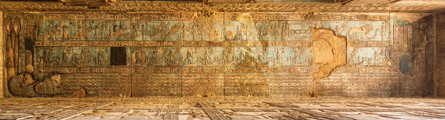 Restored ceiling painting with one panel left in its original dirty and uncleaned state in the temple of Hathor at Dendera