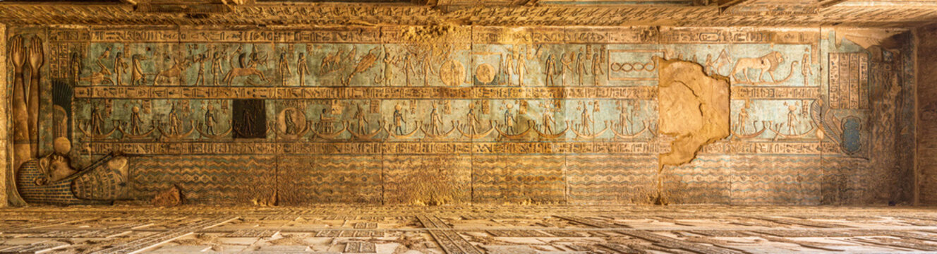 Restored ceiling painting with one panel left in its original dirty and uncleaned state in the temple of Hathor at Dendera