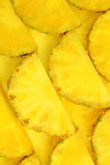 Pineapple juicy yellow slices as a background.