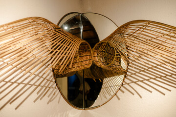Wicker Lamps Sconce. Home lighting fixture made of woven, natural material and oval mirror mounted...