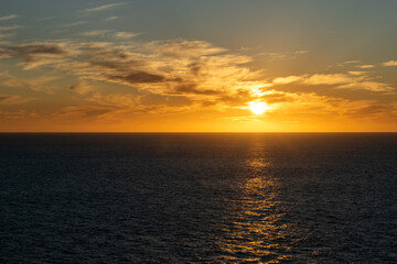 Obraz premium Beautiful sunset with great cloudscape over the Pacific and the reflection of the sun in the sea.